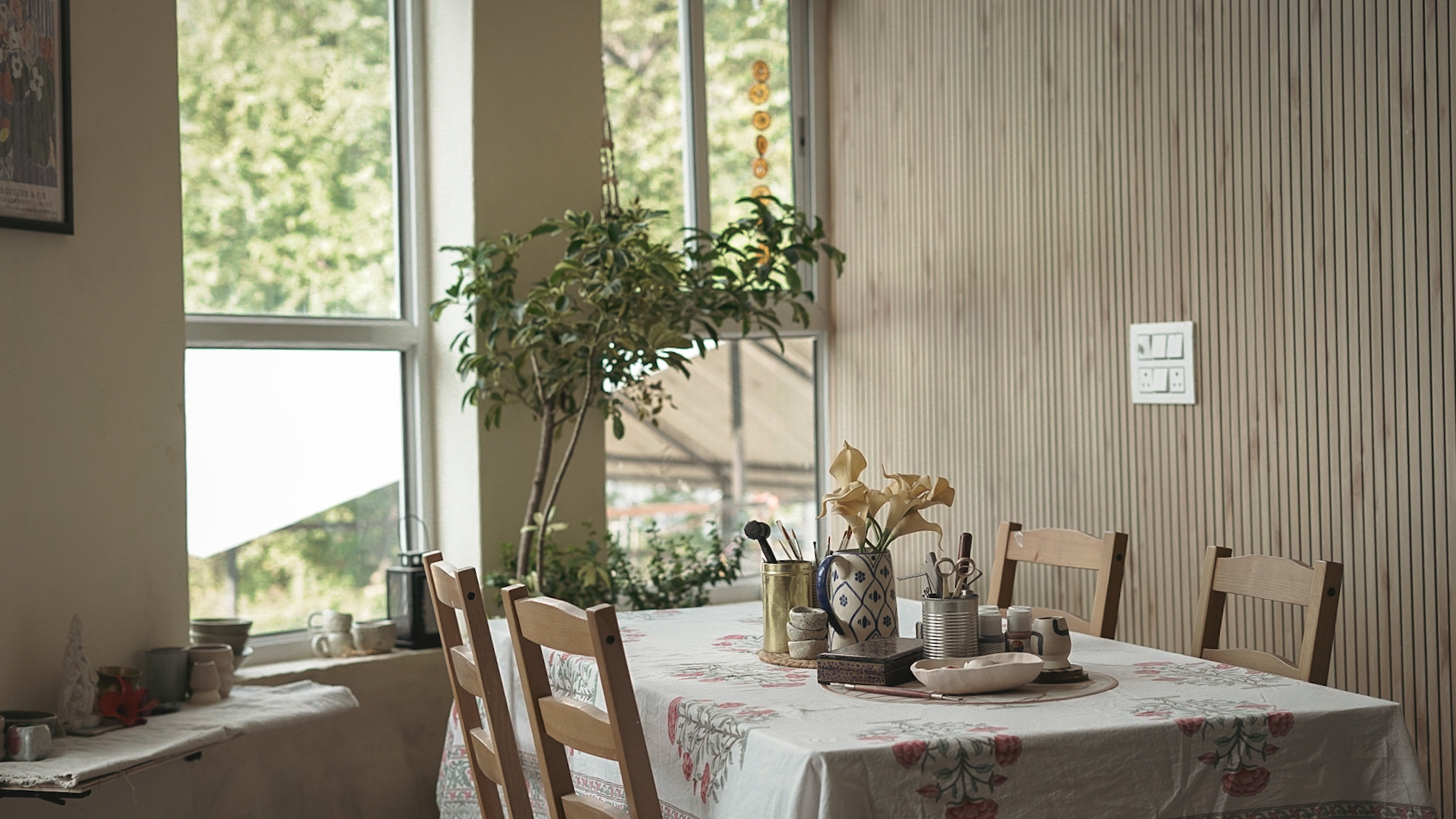 Studio workspace with floral tablecloth and natural light